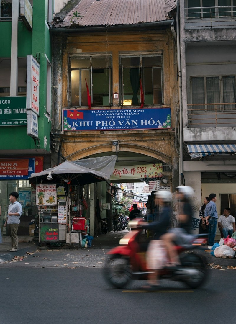 Motorbike passing an old shophouse in Ho Chi Minh City