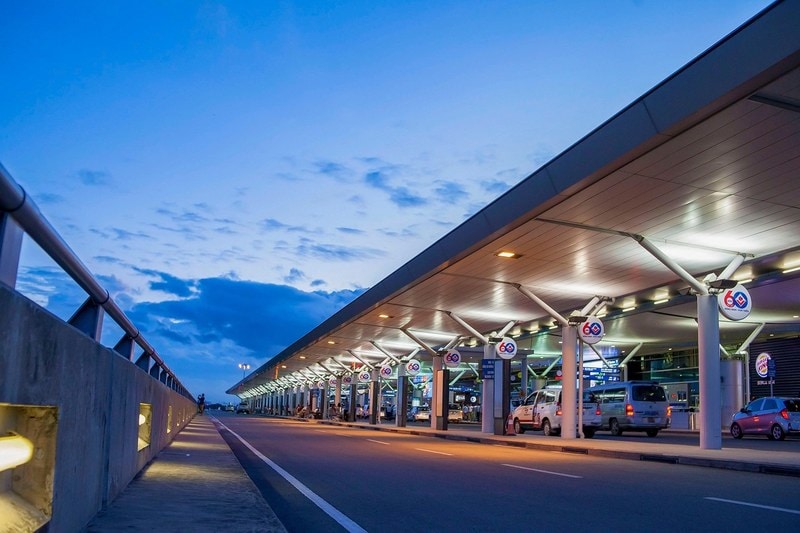 Departures road outside an airport terminal in Vietnam at dusk