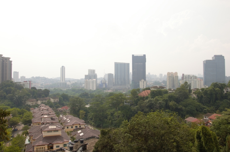 Houses and high-rise towers among trees in Kuala Lumpur