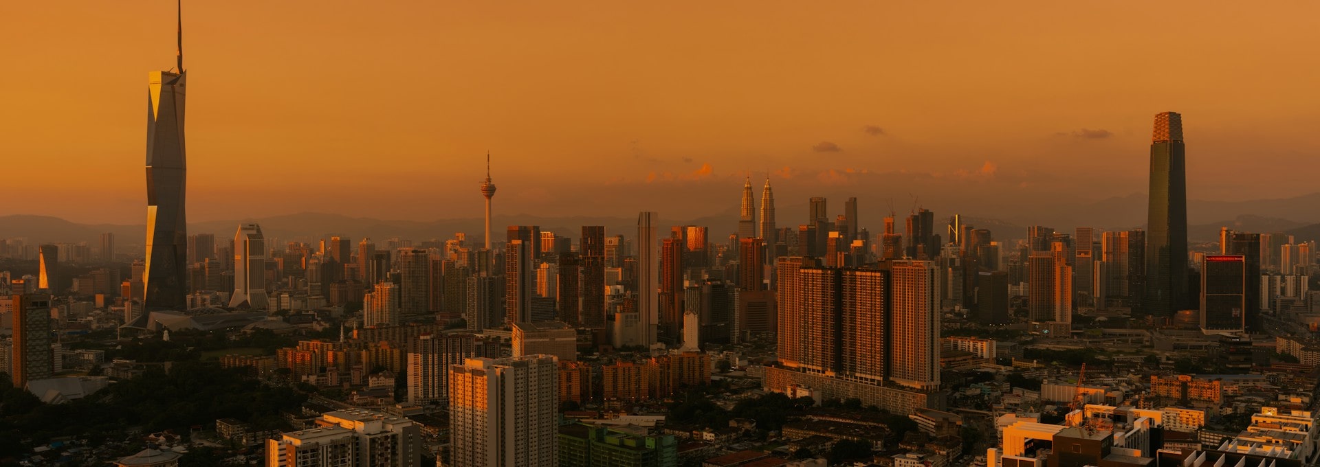 Kuala Lumpur skyline at sunset with Merdeka 118, KL Tower and the Petronas Twin Towers