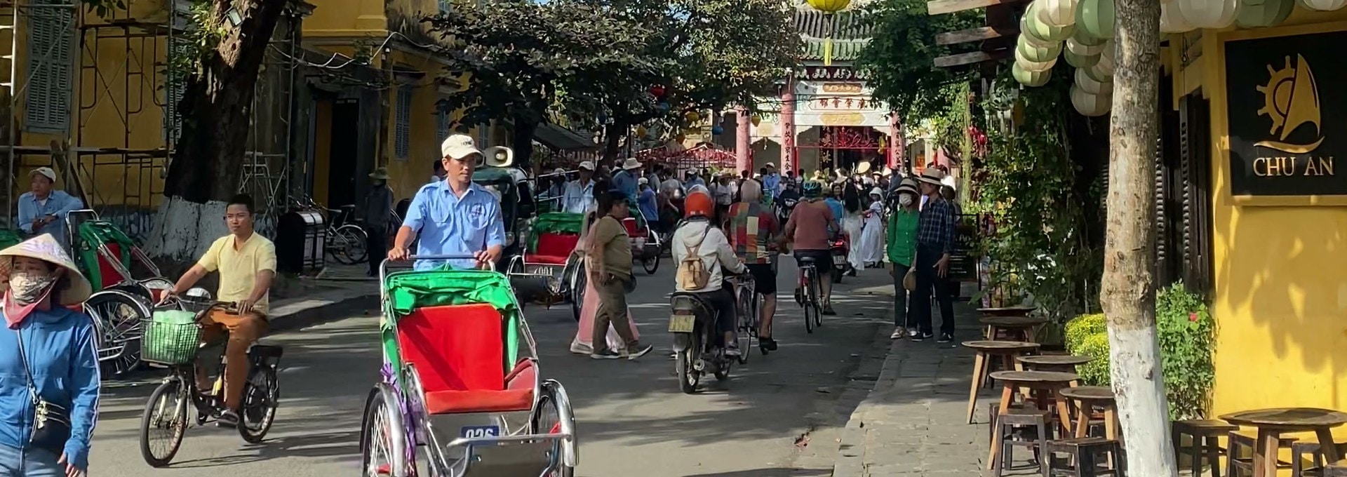 Lanterns and a cyclo on a street in Hoi An's old town, Vietnam
